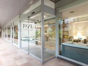 a store front with glass doors and a table at Luze Castellana in Madrid