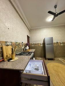 a kitchen with a stove and a refrigerator at 2BR & 3BR Sea View Condos in Dar es Salaam