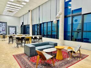 a lobby with chairs and tables in a building at Scarletz Suites KLCC by M Suites in Kuala Lumpur