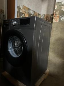 a black washing machine sitting in a room at 2BR & 3BR Sea View Condos in Dar es Salaam