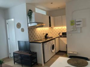 a small kitchen with a washing machine in it at Studio entier - Stade de France Paris in Saint-Denis