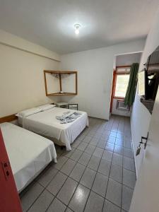 Postel nebo postele na pokoji v ubytování Pousada Itaúnas