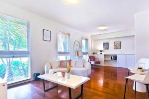 a living room with a couch and a table at Mel Eastern Villa near everything in Doncaster East