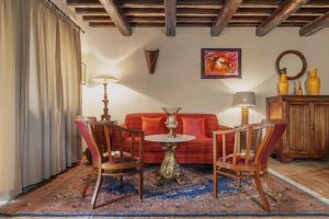 a living room with a couch and a table and chairs at Borgodoro - Natural Luxury Bio Farm in Magliano Sabina