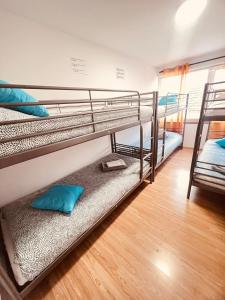 a room with two bunk beds and a wooden floor at G & S - Hostel Vila do Conde in Gião