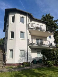 a tall white building with a balcony on it at Sunset Apartment mit Rheinblick in Urbar in Urbar