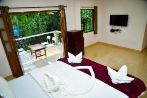 Postel nebo postele na pokoji v ubytování Idyllic Inn Calangute Goa