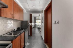 a kitchen with a sink and a counter top at Phineek Studio Apartment The Green Al Alka in Dubai