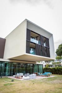 an external view of a building with couches at MarePineta Resort in Milano Marittima