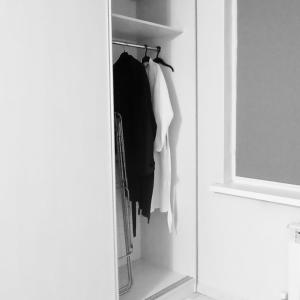 a closet with clothes hanging on a rack at ЖК Молодежный in Almaty