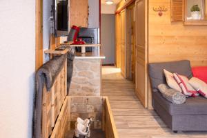 a hallway of a tiny house with a couch at Studio Les Saisies in Hauteluce