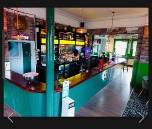 a bar in a pub with a green counter at River side rooms in Southampton