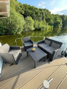 eine Terrasse mit 2 Stühlen und einem Tisch auf einem Boot in der Unterkunft Rollyboot Florina in Franzensberg