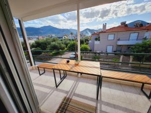 a balcony with a table and a view of a city at Luxury Loft Apartment Yiota in Patra