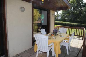 a table with white chairs sitting on a patio at Mimosas in Morcenx