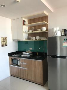 a kitchen with a stainless steel refrigerator and cabinets at Diamond Suite in Pattaya South