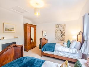 a bedroom with two beds and a fireplace at South Lodge- Uk45600 in Southwell