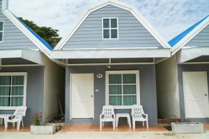 a house with a table and chairs in front of it at Preme village in Ubon Ratchathani