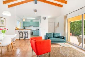 a living room with a couch and a table at Villa Libra in Cala en Forcat