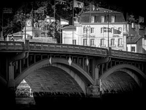 a bridge over a river with a building in the background at ibis Styles Bayonne in Bayonne