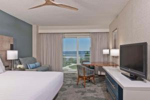 a hotel room with a bed and a flat screen tv at Hyatt Regency Chesapeake Bay Golf Resort, Spa & Marina in Cambridge