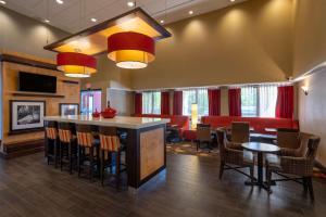 a lobby with a bar with chairs and tables at Hampton Inn Chester in Chester