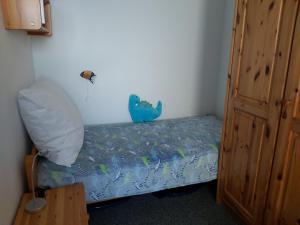 フェーマルンにあるBurgtiefe Südstrand "Windflüchter"の小さなベッドルーム(青いベッドカバー付)