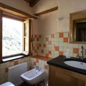 a bathroom with a sink and a toilet and a window at Agririfugio Molini in Camogli