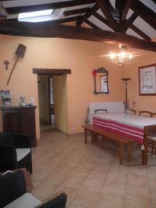 a living room with a bed and a table at Gite de gachot in Fargues