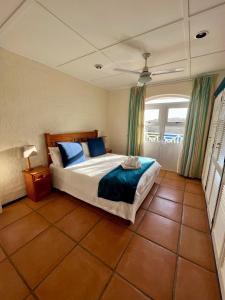 a bedroom with a large bed with blue pillows at Caribbean Estates Montego Bay 38 in Port Edward