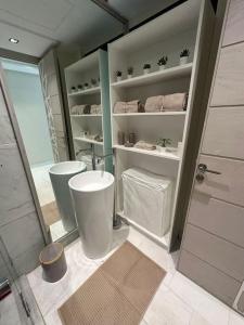 a bathroom with two white sinks and a shower at Studio neuf confort bien placer in Casablanca