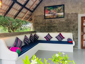a bench in a room with pillows on it at Kingfisher Beach Resort -Yala in Kirinda