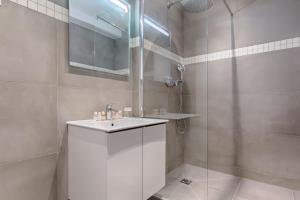a bathroom with a white sink and a shower at SD1 - Magnifique Appartement 2BR/6P - Center Paris in Paris