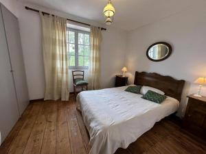 a bedroom with a large bed and a window at Chez michou ii in Horsarrieu