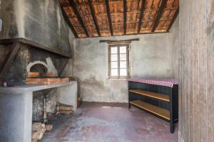 cocina antigua con fogones y ventana en Gite caperot, en Eyrès - Moncube