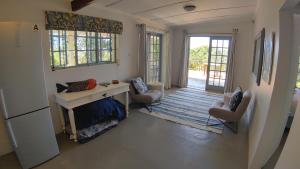a living room with a desk and two chairs at The Beach Bungalows in Zinkwazi Beach