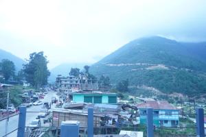 a view of a city with a mountain in the background at The Tenzin Homestay in Dirang Dzong