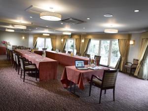 a dining room with a long table and chairs at Three Ways House Hotel in Chipping Campden