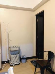 a room with a black door and a black chair at 1BR Suite in Manhattan Heights Tower D in Manila