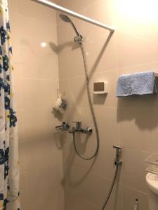 a bathroom with a shower with a glass door at 1BR Suite in Manhattan Heights Tower D in Manila