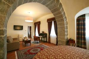 a living room with a bed and a room with a couch at Grand Hotel Dei Castelli in Sestri Levante