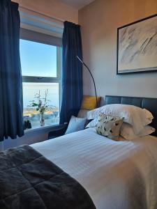 a bedroom with a bed with a view of the ocean at The Broadwater Guest House in Morecambe