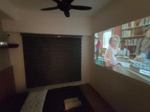 a living room with a flat screen tv on the wall at Melaka Homestay Best in Town 6+3 paxs in Melaka