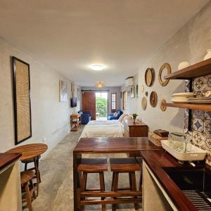 a bedroom with a bed and a kitchen with a table at Kimberly's Place - Transient House Amadeo Cavite in Amadeo +13 photos