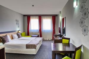 Postel nebo postele na pokoji v ubytování MPM Hotel Guinness