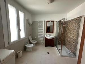 a bathroom with a shower and a toilet and a sink at 7 Cannelle Guest House in Isernia