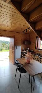 a kitchen with a wooden table in a room at Cabana Santa Cruz in São Francisco de Paula