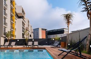 a swimming pool in the middle of a building at Glorystar The Millennial Umhlanga in Durban