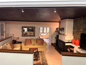 a living room with a couch and a fireplace at Casa Monte da Volta in Chaves
