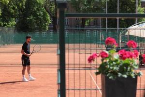 a man standing on a tennis court holding a racket at Włodary Tennis Junior in Częstochowa +32 photos